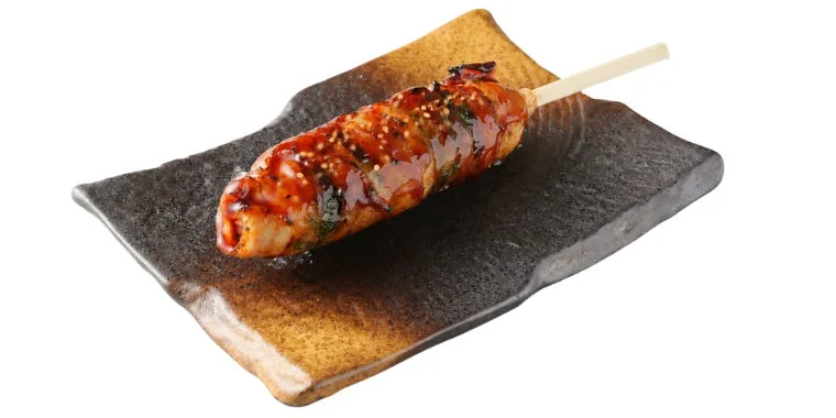 照り焼きのたれとゴマがかかった串焼き