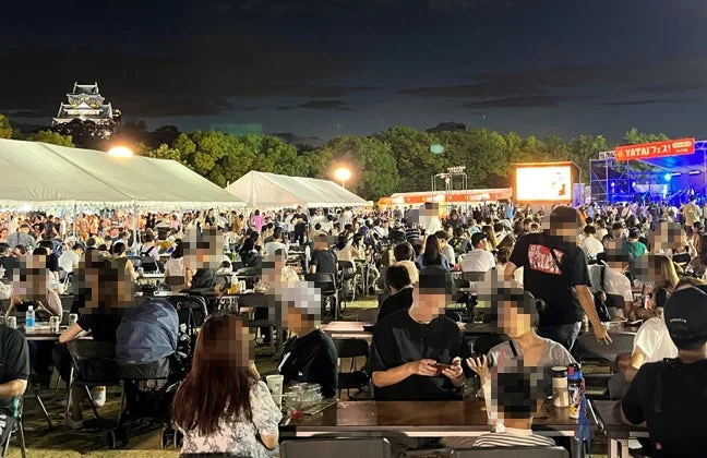 夜景に浮かぶ大阪城と賑わうフェスの様子